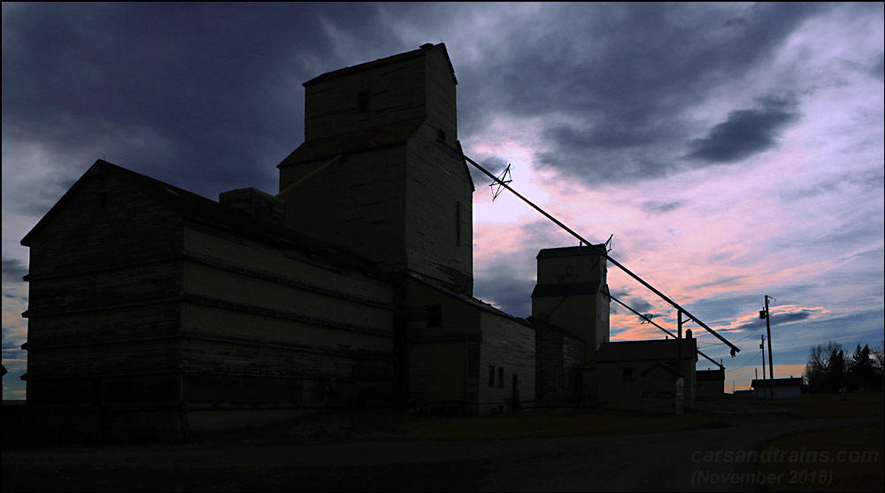 Silhouettes of grain elevators at Mossleigh, Alberta.